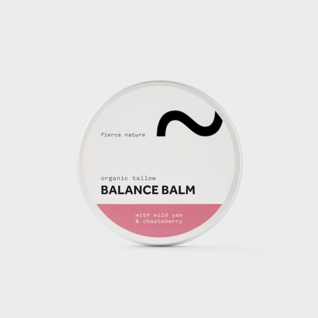 A round white tin of 'fierce nature' Balance Balm with a pink bottom band and black logo, set against a light gray background.